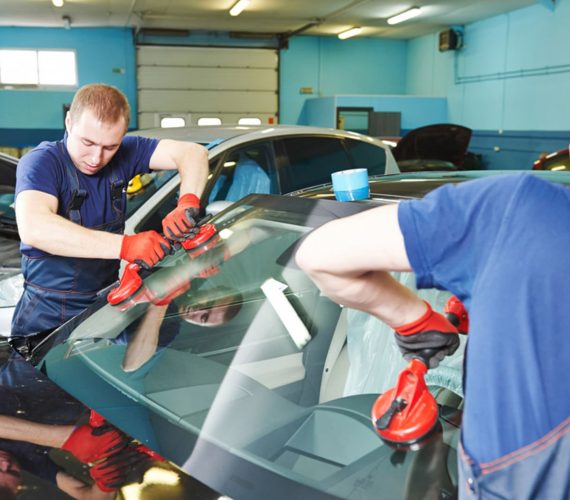 Two men replacing windshield — Windscreen Replacement Raymond Terrace, NSW
